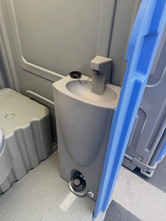 Porta potty interior with a foot-pump sink